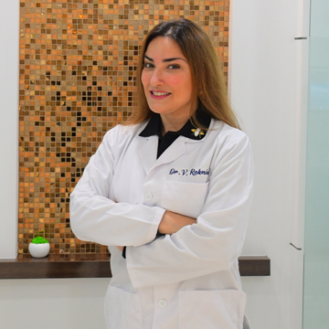 Image of Dr. Vivian Roknian in white dentists apron