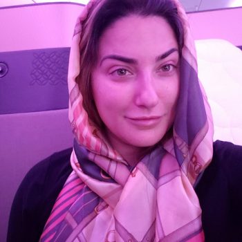 Dr. Vivian Roknian taking picture of herself in the flight
